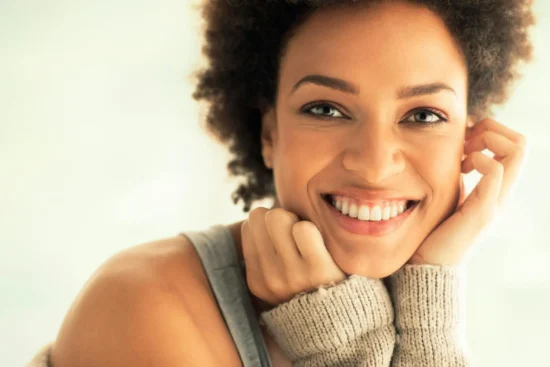 Woman smiling with hand on chin