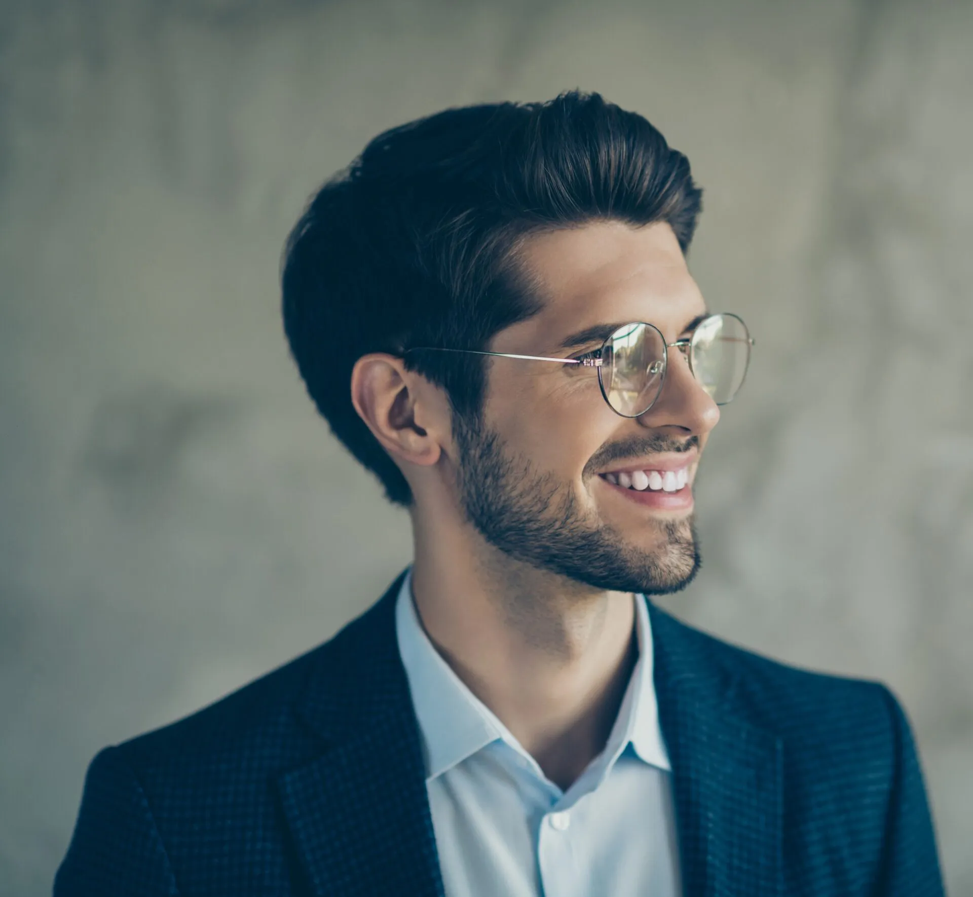 Man in glasses and suit smiling